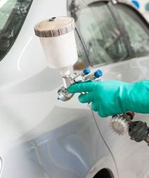 spray gun with paint for painting a car